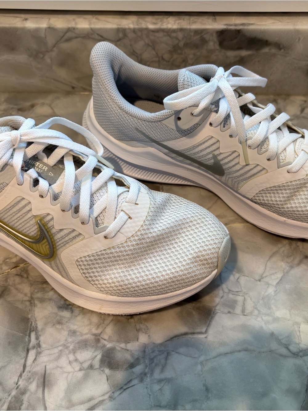 Nike Women's White & Light Gray Running Sneakers with Gold Swoosh Accent